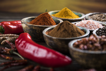 Assortment of spices in wooden bowl background 