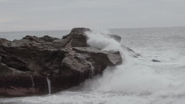 Big storm waves hitting the shore. Sea waves crashing on the rocks during the storm. Ocean waves breaking. Tidal wave