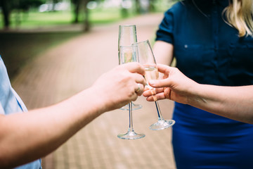 hands with glasses of champagne