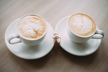 wedding rings and a Cup of coffee