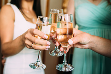hands with glasses of champagne
