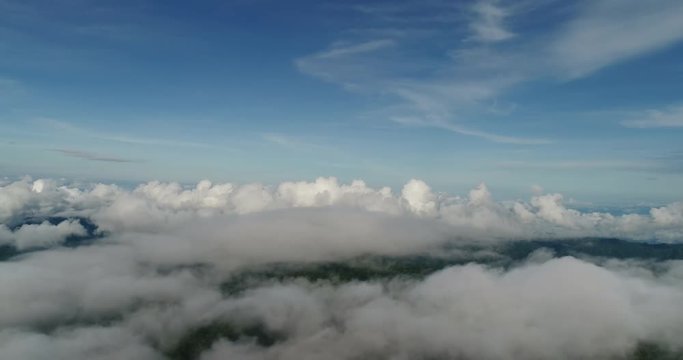 Aerial View. Flying over the beautiful mountain in clouds.