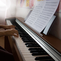 Fototapeta na wymiar Young girl playing digital piano