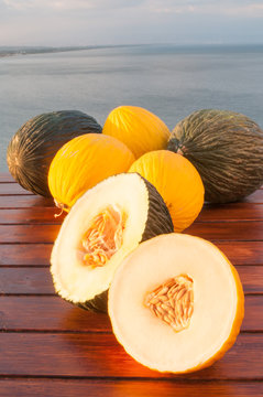 Typical mediterranean fruits: yellow melon with blue sea in the background