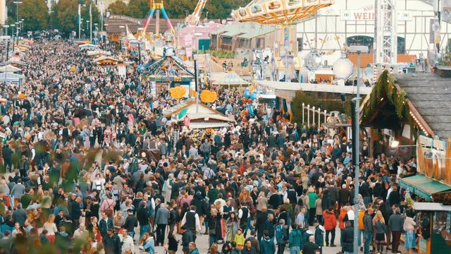 September 17, 2017 - Oktoberfest, Munich, Germany:View of the huge crowd of people walking around the Oktoberfest in national bavarian suits, on Theresienwiese, top view