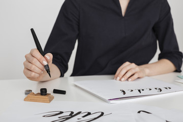 Beautiful photo of young woman hands writing on paper on desk  isolated
