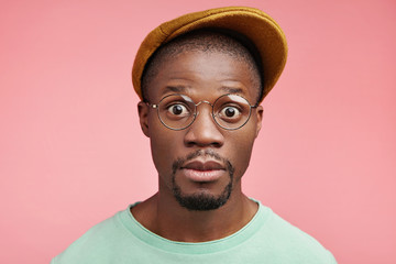 Shocked black African American male driver realizes that his car is brocken, has no instruments for...
