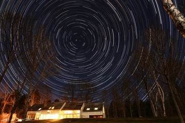 Star Spin Over Lit House
