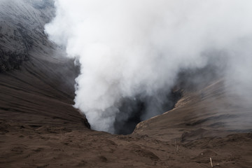 Fototapeta premium Volcanic eruption, close up on crater with smoke, Mount Bromo, Indonesia
