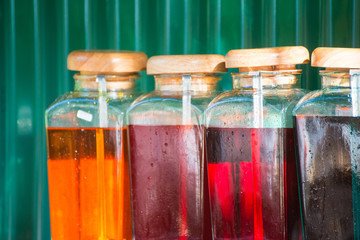 Colorful sweet syrup in glass bottles