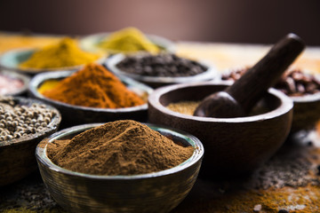 Assortment of spices in wooden bowl background 