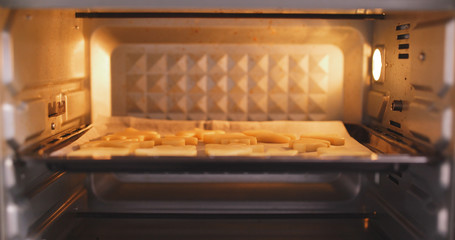 Placing cookies into oven