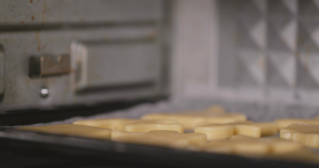 Placing cookies into oven