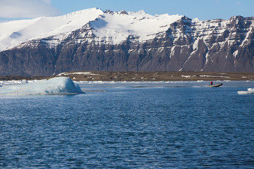 Snow covered volcano rock over winter season lagoon, natural landscape background, Iceland