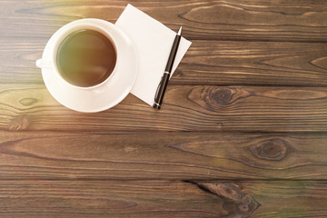 cup of coffee ball pen paper napkin on a wooden background