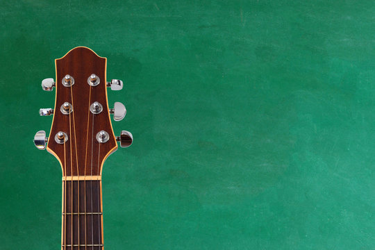guitar with blackboard on background , concept of music school