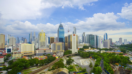 Obraz premium Kuala Lumpur city skyline during summer with dramatic blur sky at background.