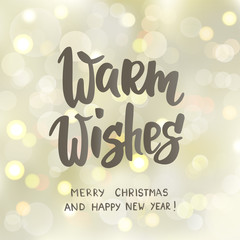 Warm wishes text, hand drawn letters. Holiday greetings quote. White and gold sparkling glowing lights.