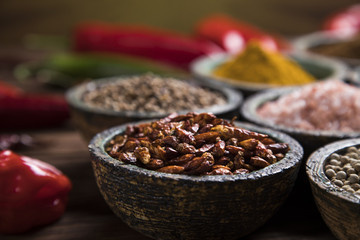 Assortment of spices in wooden bowl background 