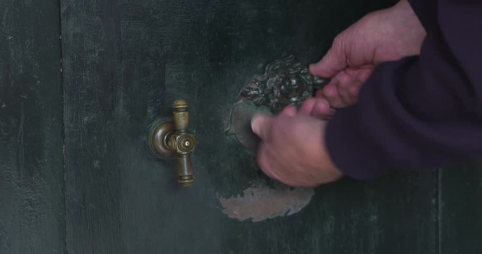 unlock and open the reinforced door of a bank vault, using a key and handle. Rattling keys and squeaking door.