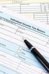 Tax form with pen; document are mock-up