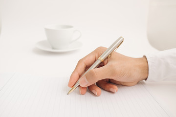 Businessman writing in a document, Focused on a hand with pen. 
