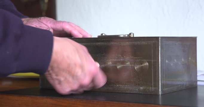 Unlock a safe deposit box with a key and open the lid