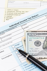 Obraz premium Tax form with pen, and dollar banknote; document are mock-up