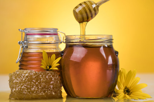 Jar full of fresh honey and honeycombs