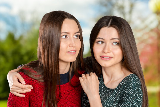 Two women gossip
