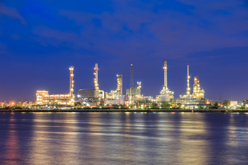 Oil refinery on water front at twilight