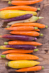 Rainbow carrots on a rustic wooden background. Healthy eating concept