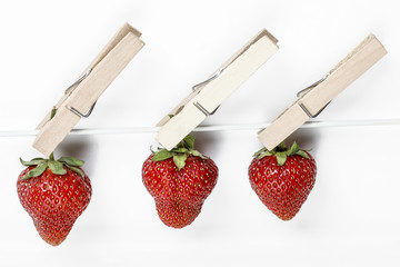 Strawberries hanging on the line