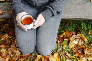 Woman sitting in autumn garden