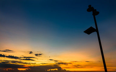 lamp post silhouette with sunset sky.