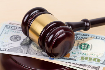 Judge wooden gavel with dollar money banknote concept for bribery