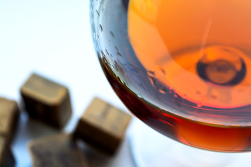 Cognac with dark chocolate on white background