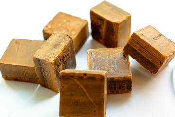 Chocolate cubes on heap, pieces of bitter, dark chocolate bar, on white background, top view