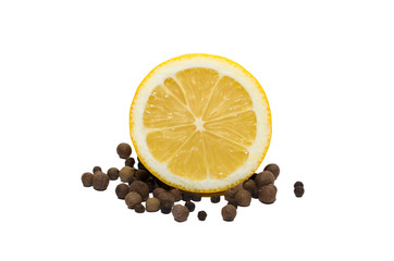 Lemon and black pepper. One whole lemon and its half and black pepper in peas isolated on white background