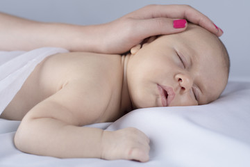 Cute newborn baby hand holding mother