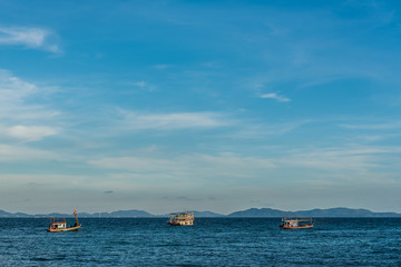 Fisherman boat on the sea with blue sky.