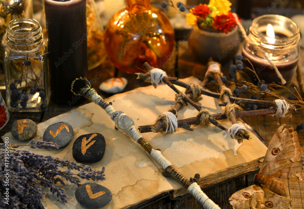 Wall mural Runes, magic wand and pentagram on witch table