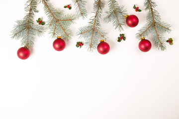 Christmas frame composition. Christmas gift,pine branch, red balls, envelope, white wood snowflakes, ribbon and red berries. Top view, flat lay, copy space