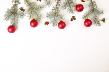 Christmas frame composition. Christmas gift,pine branch, red balls, envelope, white wood snowflakes, ribbon and red berries. Top view, flat lay, copy space