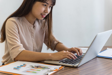 Close-up of woman hand typing on laptop