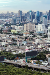 aerial cityscape of modern office and condominium buildings with green area in foreground, old film look filter effect