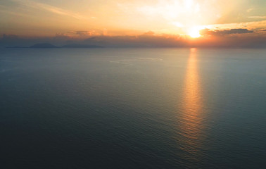 Aerial view. A calm and empty ocean during sunrise.