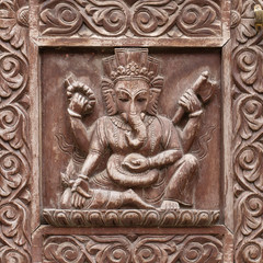 Fototapeta na wymiar Detail wooden carved door in hindu temple, Kathmandu, Nepal background. Vintage antique door with ornament