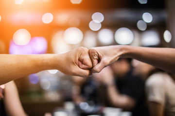 businessman giving Fist bump or Knuckle bump during Meeting for success and agreement to express teamwork/togetherness and cooperation concept in blur background