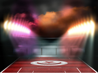 Football stadium with Tunisia flag textured field. Night scene. Photo manipulation